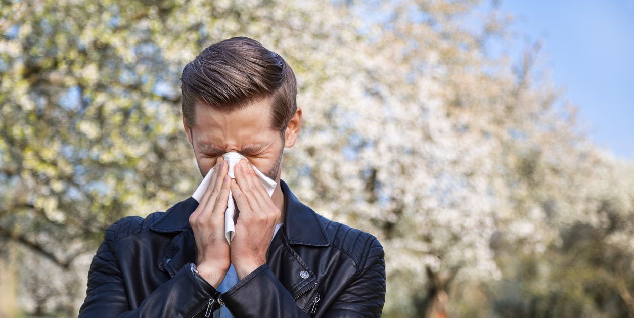 A man suffering from allergies in spring